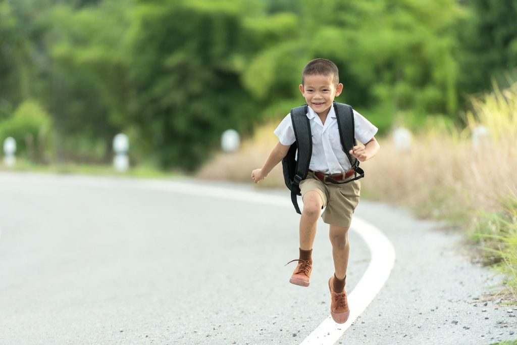 boy skipping down the street