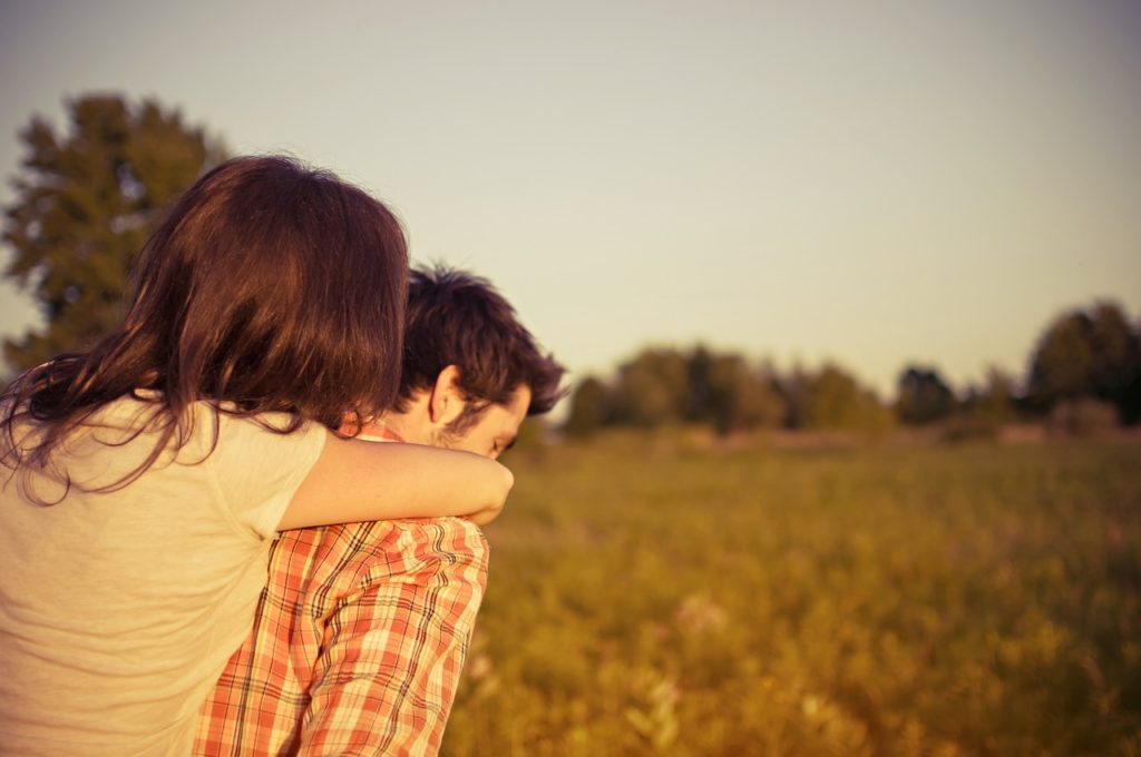 teenage couple carrying each other