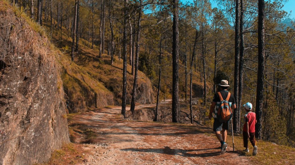 Father and adopted son hiking. 